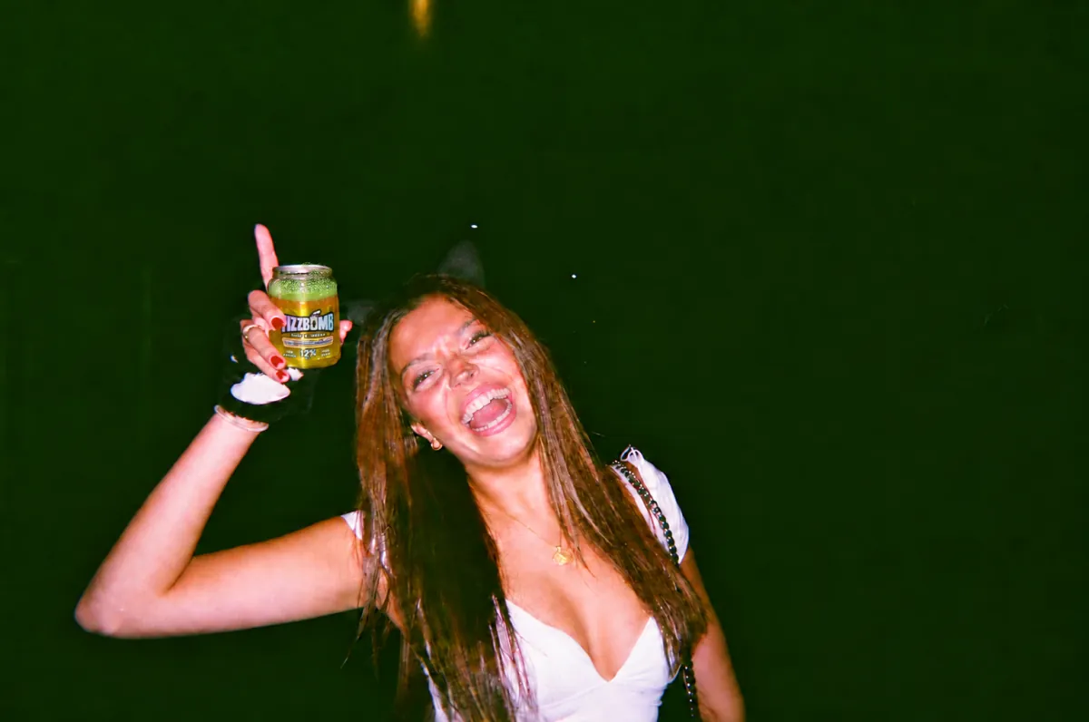 A friend dancing with a FizzBomb can held high